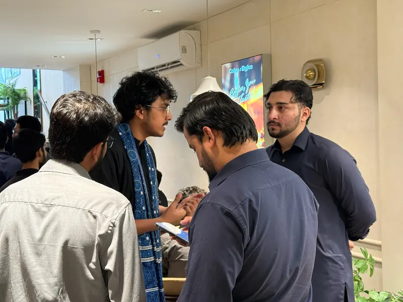 Faseeh talking with guests during the networking part of UnMixer