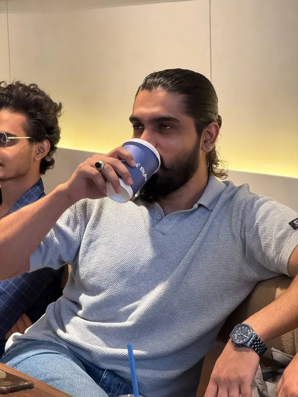 A guest at UnMixer drinking coffee from a Caby & Byke cup
