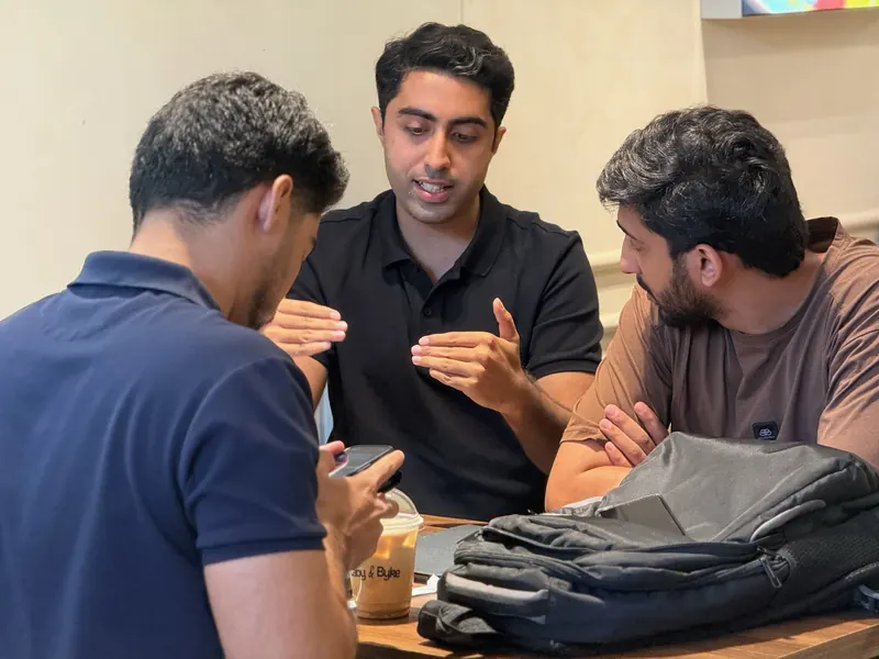 Three guests at UnMixer talking across a table
