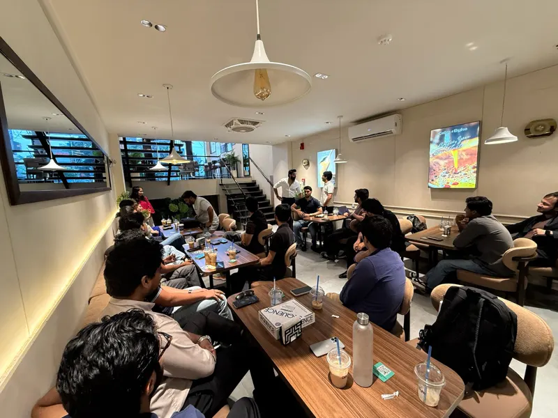 A wide view of the room with guests seated at every table